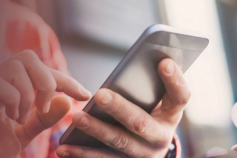 a person's hands using a phone