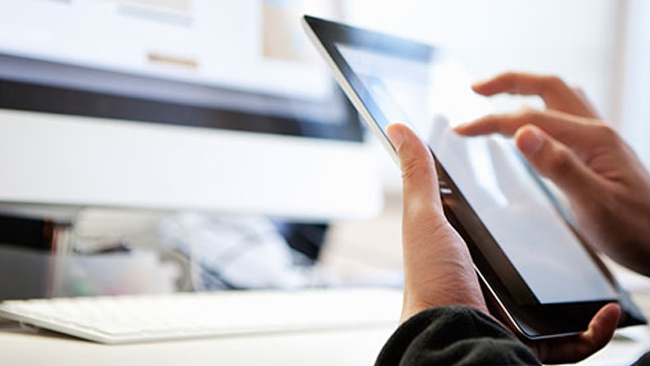 hands holding a tablet