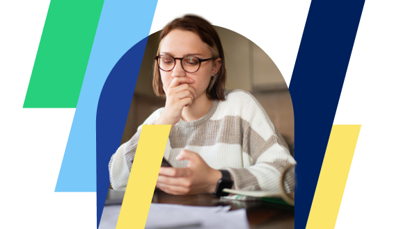 A woman sitting at a table looking at her phone